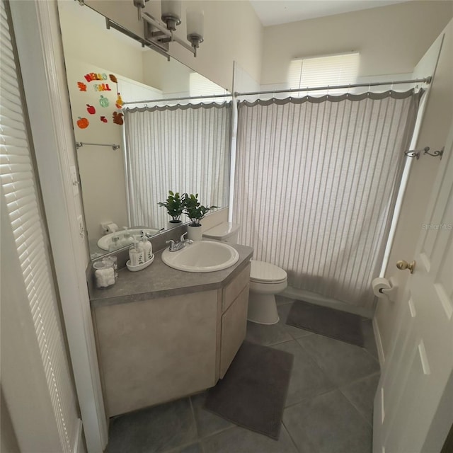 full bathroom featuring tile patterned flooring, vanity, shower / tub combo, and toilet