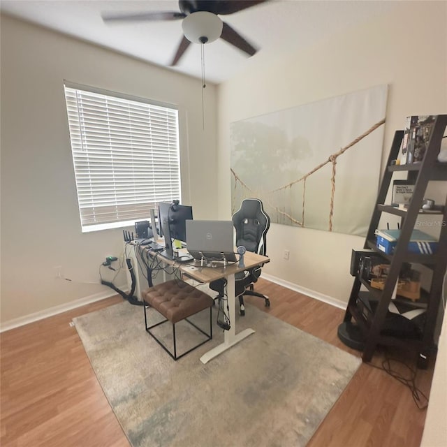 home office with wood-type flooring and ceiling fan