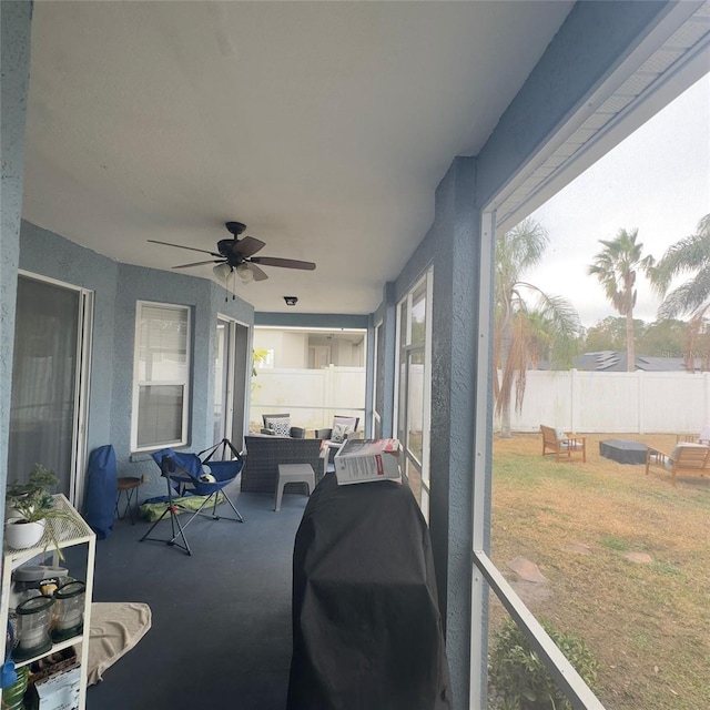 sunroom / solarium featuring ceiling fan