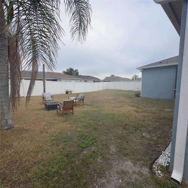 view of yard with an outdoor fire pit