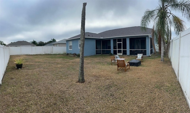 back of property featuring a yard and a sunroom