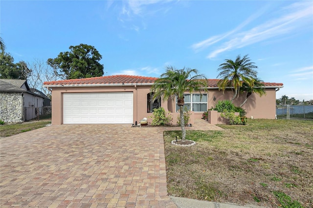 view of front facade with a garage and a front lawn