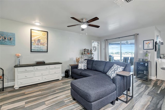 living room with ceiling fan and dark hardwood / wood-style flooring