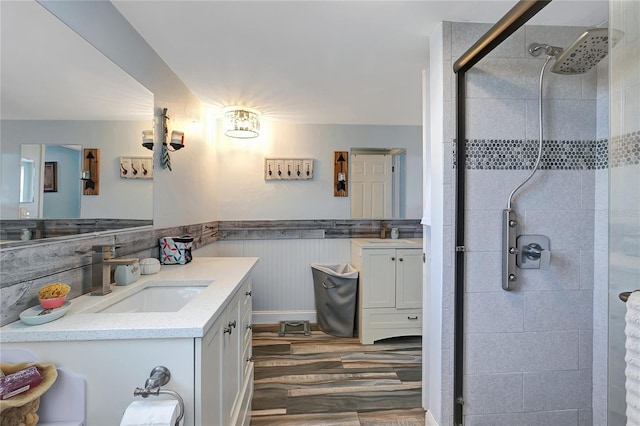 bathroom featuring vanity, wood-type flooring, and walk in shower