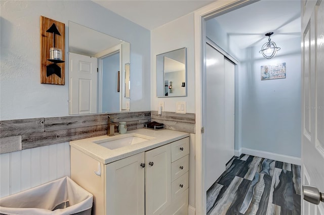 bathroom with hardwood / wood-style floors and vanity