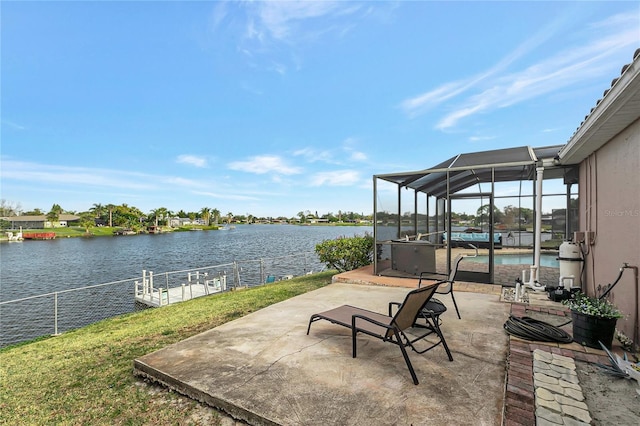 view of patio featuring a lanai and a water view