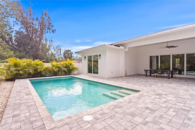 view of pool with a patio and ceiling fan