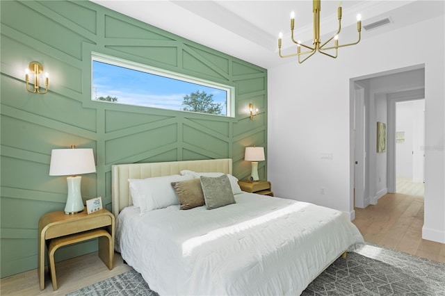 bedroom featuring a chandelier and wood-type flooring