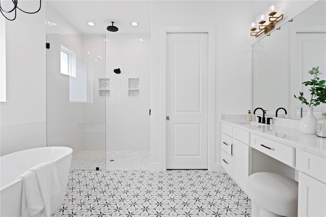 bathroom with vanity and independent shower and bath