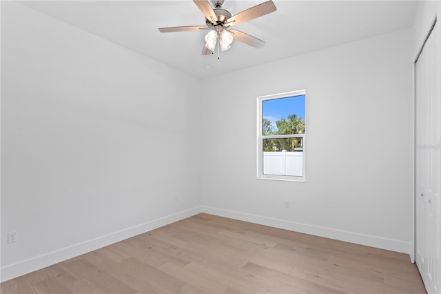 empty room featuring light wood-type flooring and ceiling fan