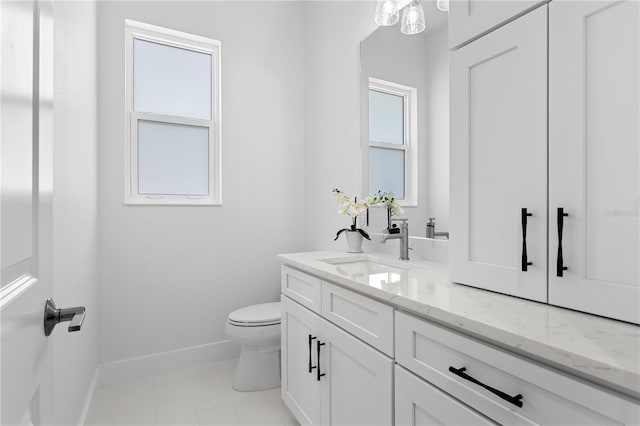 bathroom featuring tile patterned floors, vanity, and toilet