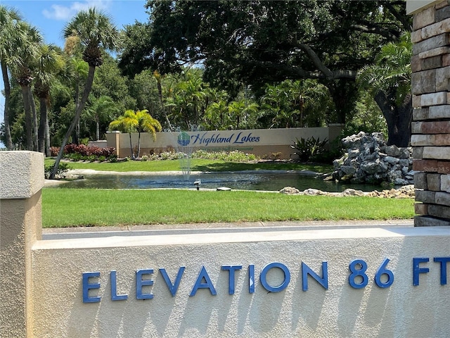 community / neighborhood sign with a yard