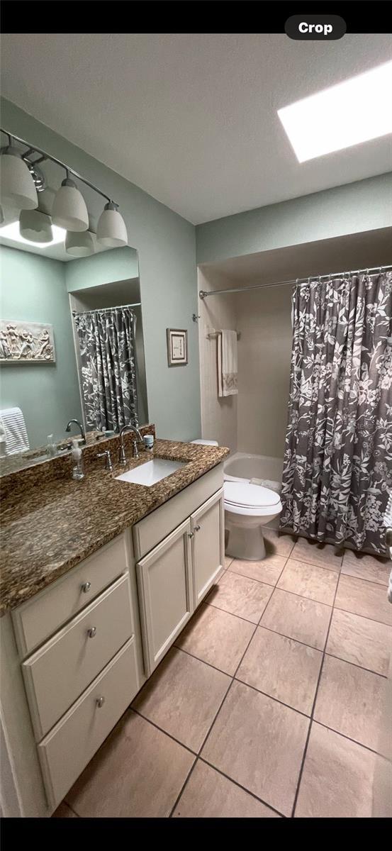 bathroom with tile patterned floors, vanity, and toilet