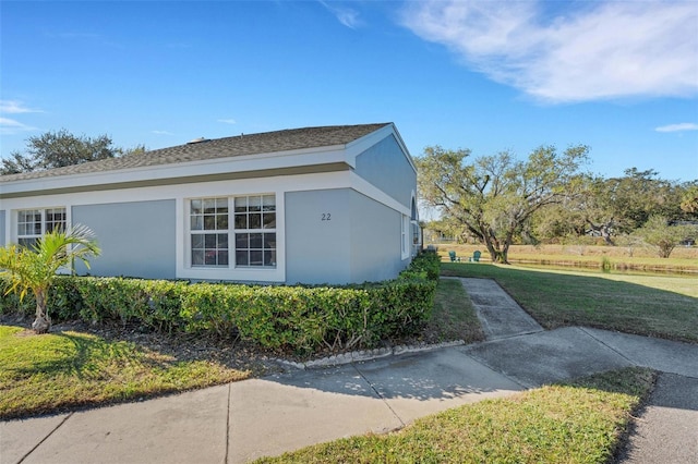 view of property exterior with a yard