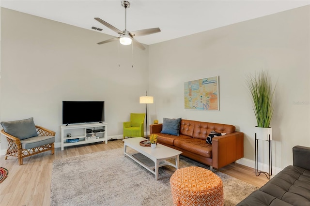 living room featuring ceiling fan and wood-type flooring