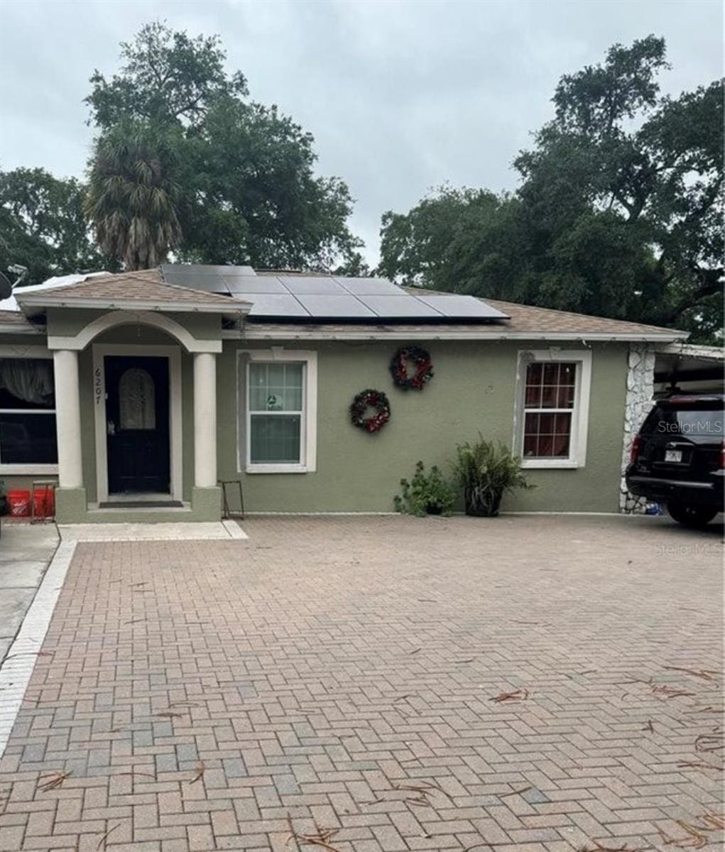 view of front of property featuring solar panels