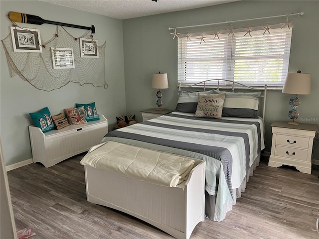 bedroom featuring a textured ceiling and dark wood-type flooring