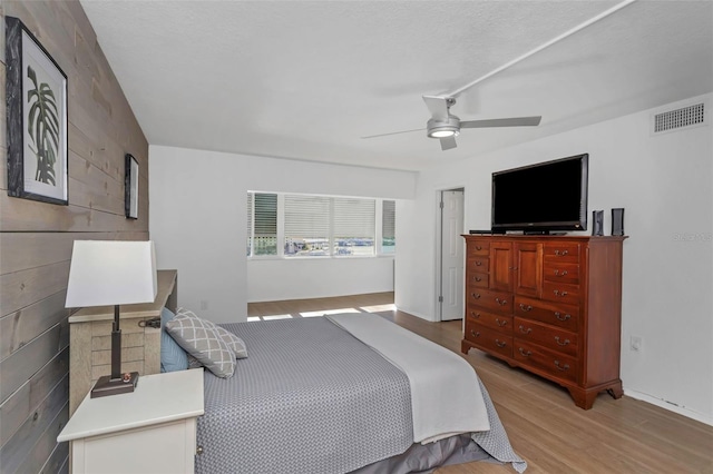 bedroom with light wood-type flooring and ceiling fan