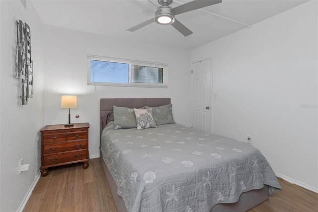 bedroom featuring hardwood / wood-style flooring and ceiling fan