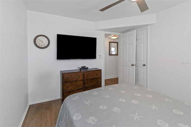 bedroom with ceiling fan, wood-type flooring, and a closet