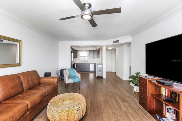 living room featuring crown molding, dark hardwood / wood-style flooring, and sink