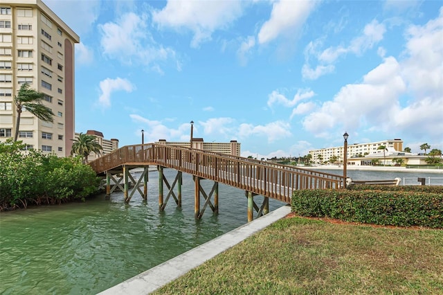 dock area with a water view and a lawn