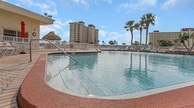 view of swimming pool with a water view and a patio