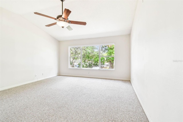 unfurnished room featuring carpet, vaulted ceiling, and ceiling fan