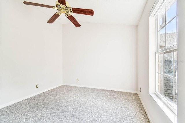 carpeted empty room featuring a wealth of natural light and ceiling fan