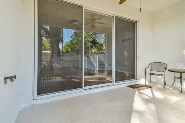 doorway to property featuring ceiling fan