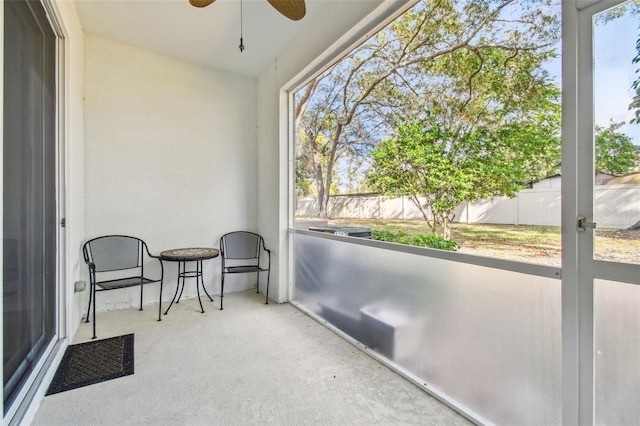 sunroom featuring ceiling fan