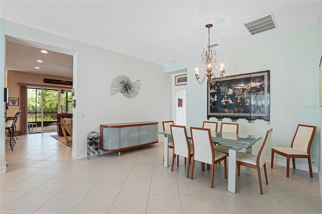 dining area featuring light tile patterned floors and an inviting chandelier