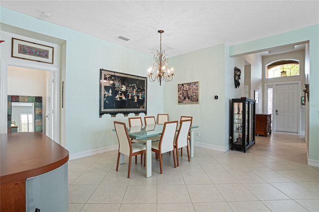 tiled dining space with a chandelier