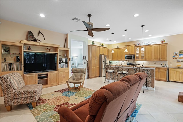 tiled living room featuring ceiling fan