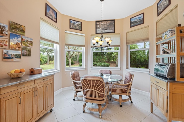 dining area featuring light tile patterned flooring and a chandelier