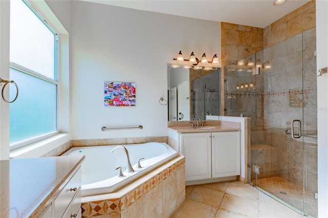 bathroom featuring vanity, separate shower and tub, and plenty of natural light