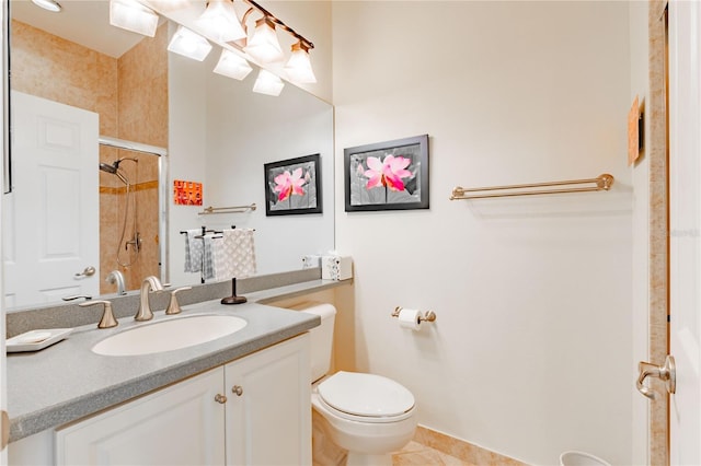 bathroom with tiled shower, vanity, toilet, and tile patterned flooring