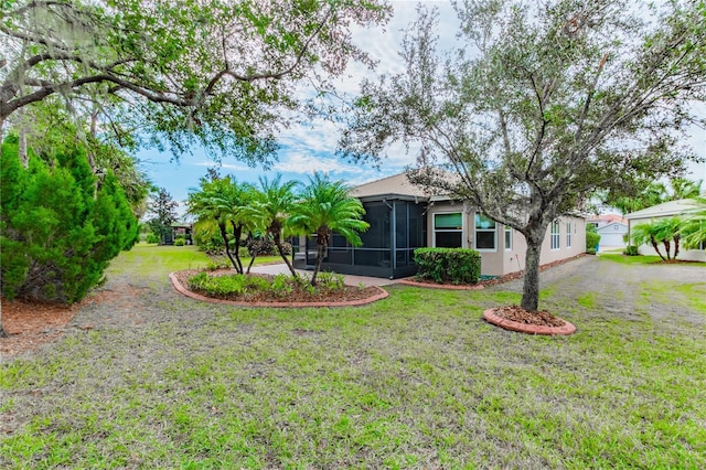 view of front of house with a front yard and a sunroom