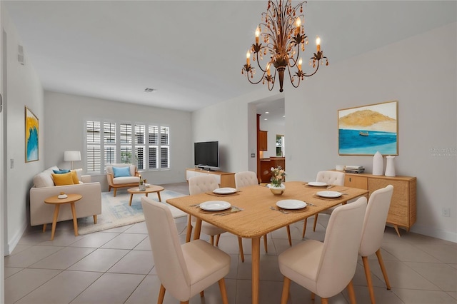 dining room with baseboards, a chandelier, light tile patterned flooring, and visible vents