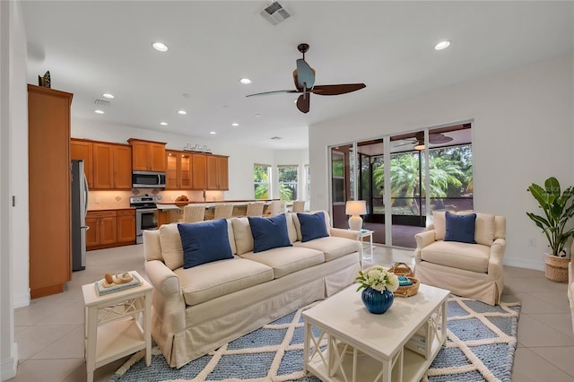 living room featuring recessed lighting, a ceiling fan, visible vents, and light tile patterned floors