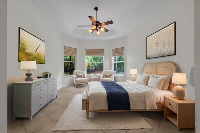 bedroom with a ceiling fan and light tile patterned flooring