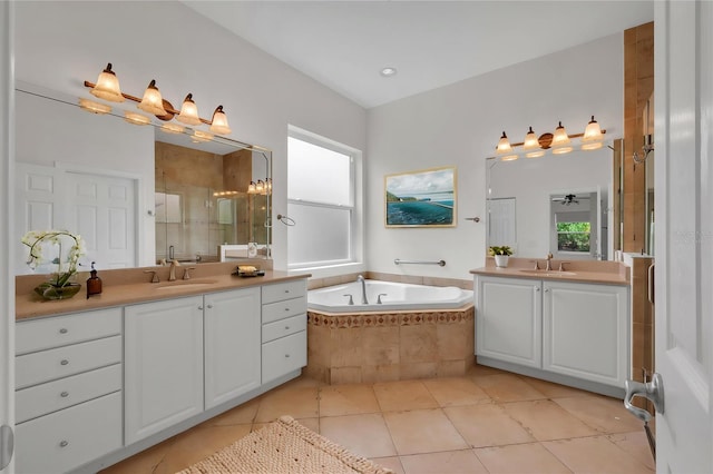 bathroom with two vanities, a healthy amount of sunlight, a sink, and a stall shower