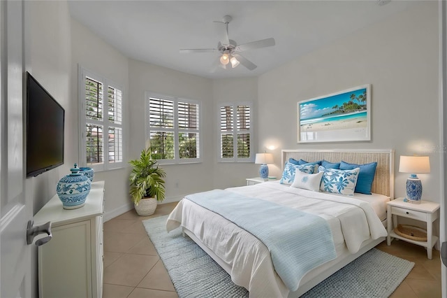bedroom featuring light tile patterned floors, baseboards, and ceiling fan