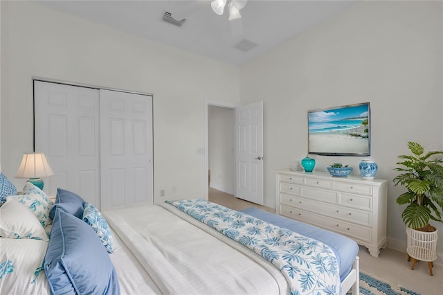 bedroom featuring visible vents, a closet, baseboards, ceiling fan, and light tile patterned floors