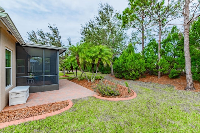 view of yard with a sunroom and a patio area