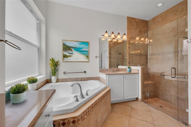 bathroom featuring a garden tub, vanity, tile patterned floors, a shower stall, and a notable chandelier
