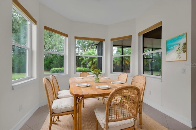 sunroom with tile patterned flooring and baseboards