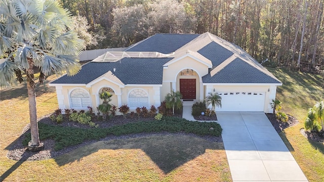 ranch-style home with a garage and a front yard