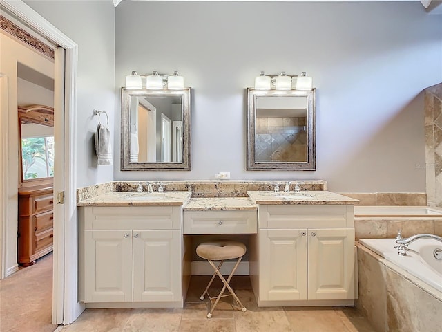 bathroom featuring tiled bath and vanity