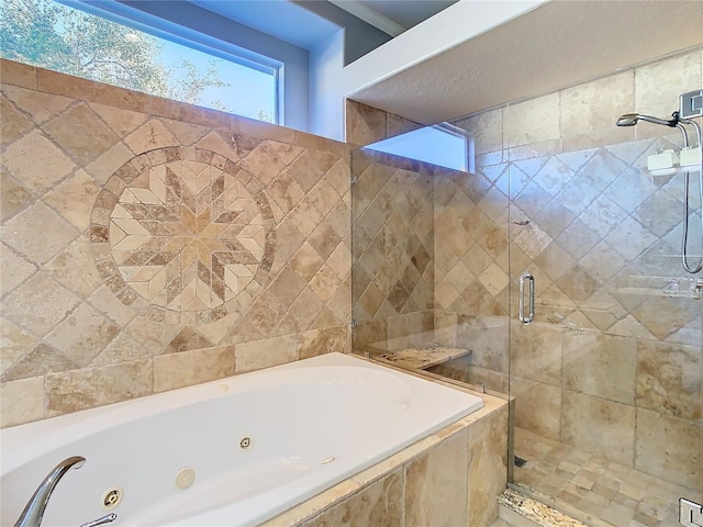 bathroom featuring separate shower and tub